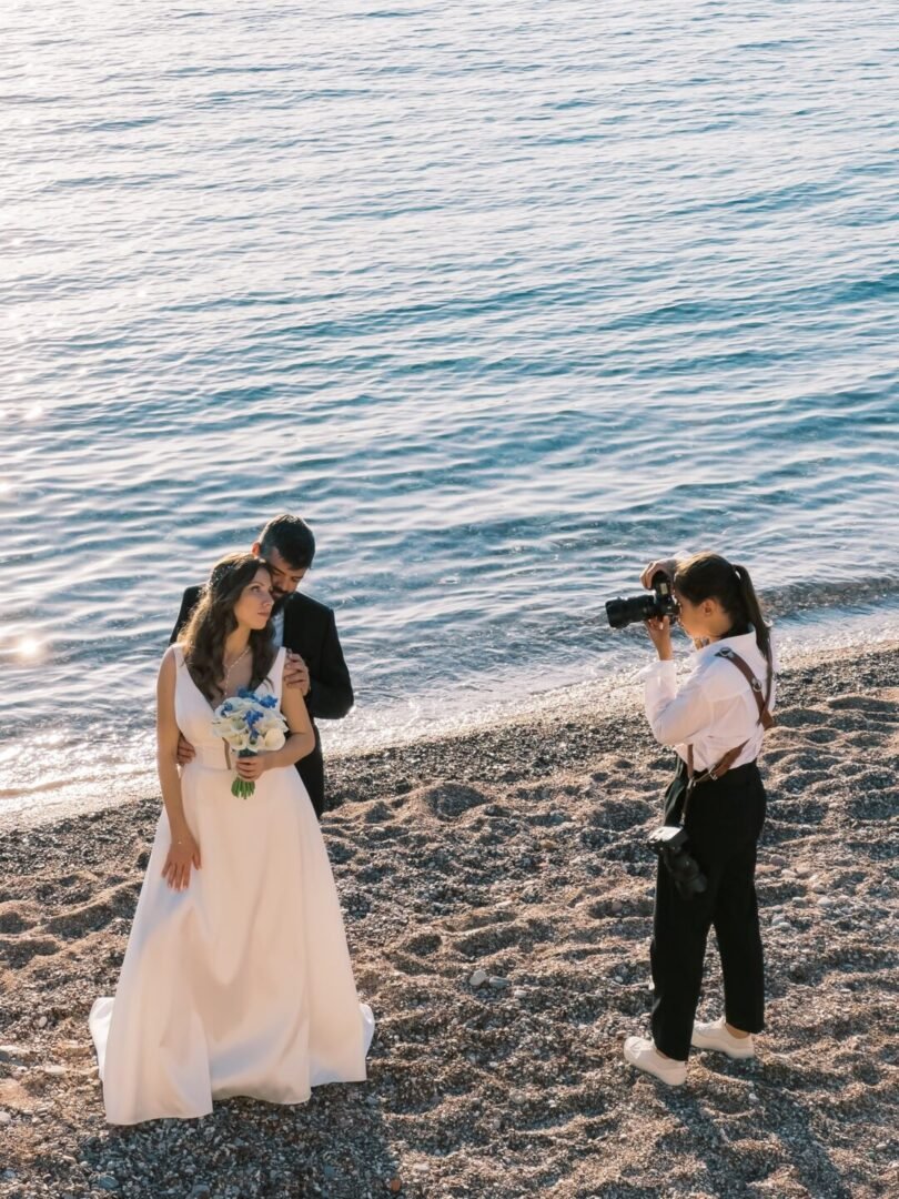Wedding photographer capturing a couple embracing on the beach