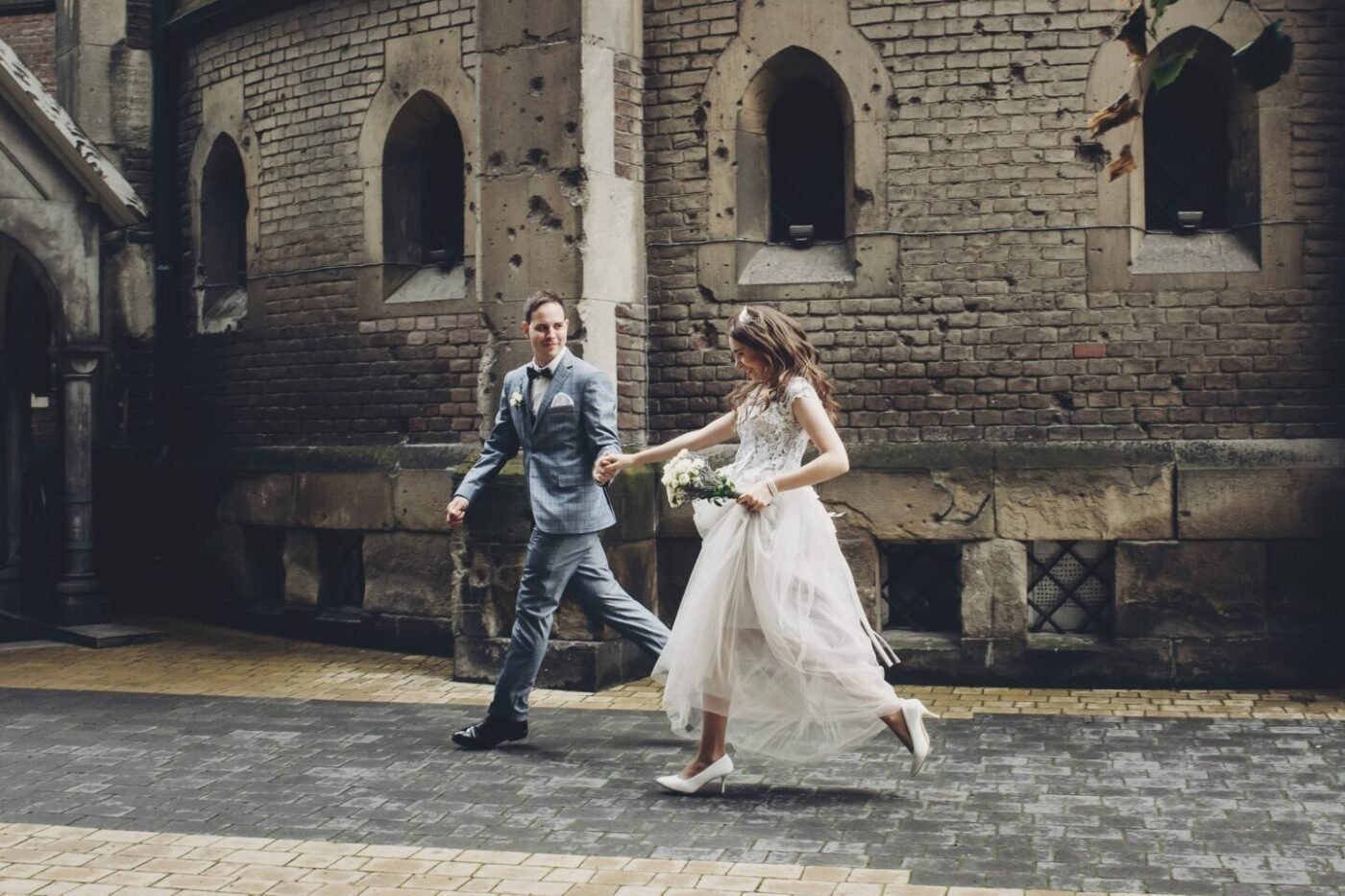 Couple running and smiling in a European city